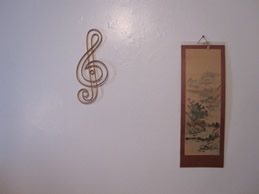 Treble clef and Chinese art on bedroom wall